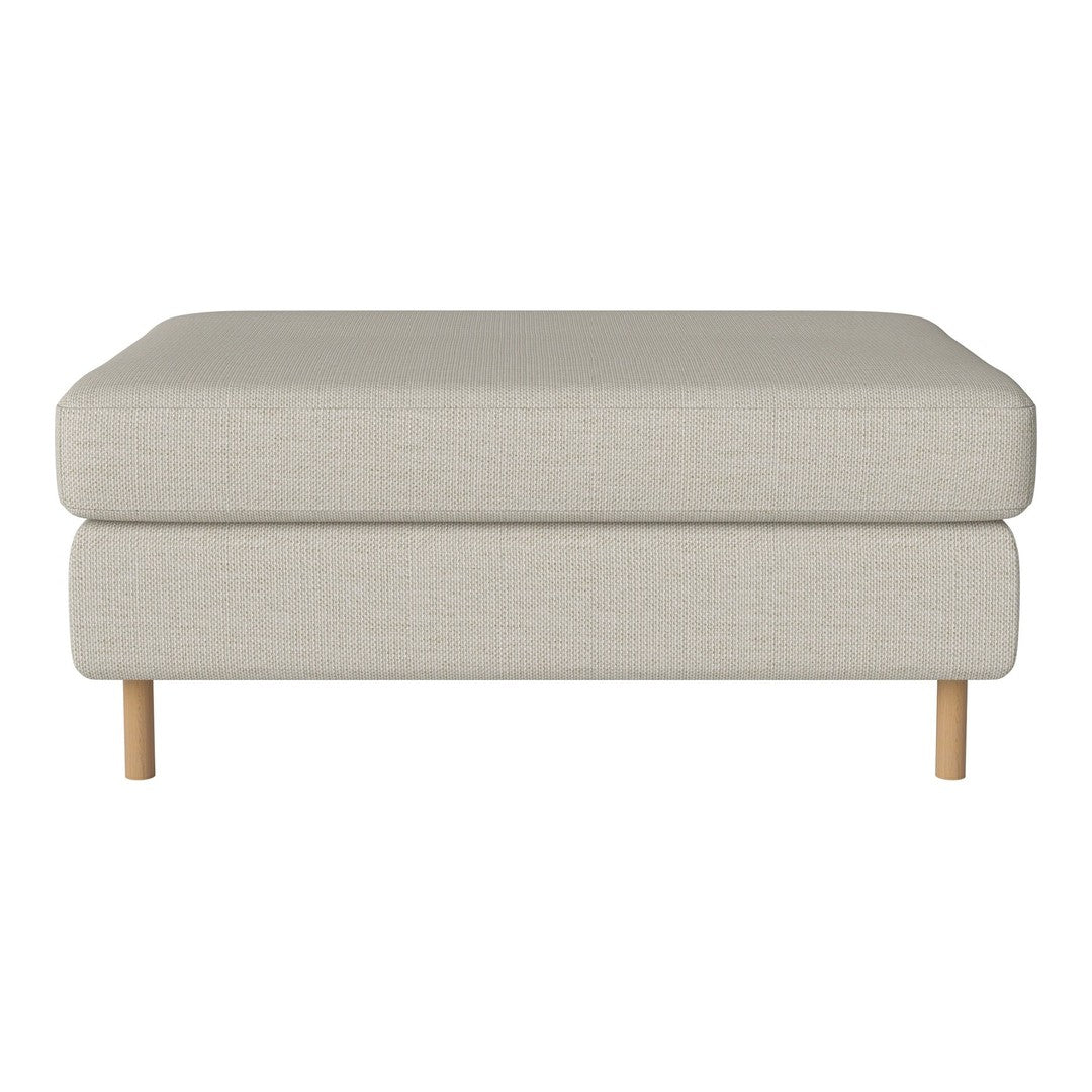 Light beige upholstered ottoman with simple, solid design and natural wood legs. Ideal for modern decor.