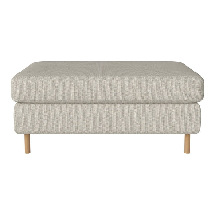 Light beige upholstered ottoman with simple, solid design and natural wood legs. Ideal for modern decor.