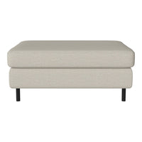 Light beige upholstered ottoman with a smooth texture and sleek black legs.