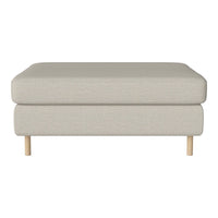 Neutral beige upholstered ottoman with a smooth texture and light wood legs, perfect for versatile home decor.
