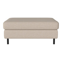 Beige upholstered ottoman with a smooth surface and black metal legs, perfect for modern interiors.