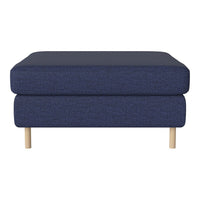 Navy blue upholstered ottoman with a sleek, minimalist design and light wooden legs. Perfect for modern decor.