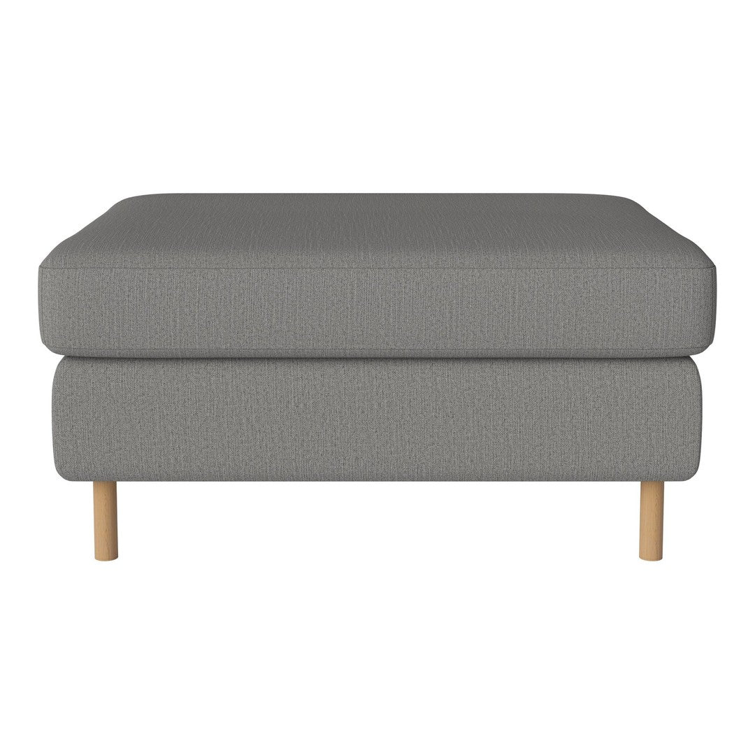 Gray upholstered ottoman with subtle textured pattern and light wooden legs. Stylish and modern design for any decor.