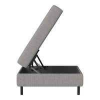 Gray upholstered storage ottoman with a minimalist design and sleek black base.