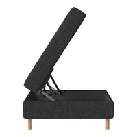 Modern black upholstered storage ottoman with textured fabric and light wooden legs. Ideal for chic decor.