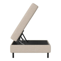 Beige upholstered storage ottoman with a subtle texture and black frame. Modern design, ideal for any decor.