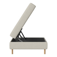 Light beige upholstered storage ottoman with wooden legs, showcasing a minimalist design and sleek lines.