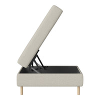 Light gray upholstered storage bed with wood legs and a clean, minimalist design for modern decor.