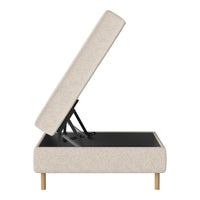 Light beige upholstered storage bed with wood legs and sleek, minimalist design.
