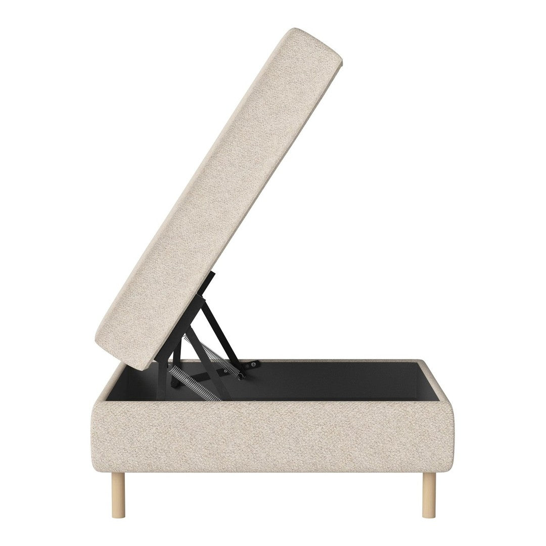 Beige upholstered storage ottoman with neutral fabric and light wood legs, featuring a simple and modern design.
