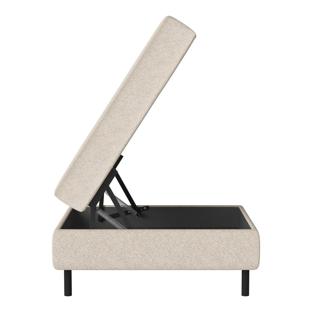 Tan upholstered storage ottoman with a textured surface and black base. Modern design with clean lines.