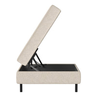 Tan upholstered storage ottoman with a textured surface and black base. Modern design with clean lines.