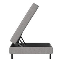 Gray upholstered storage ottoman with a sleek, minimalist design and a black base, showcasing a modern aesthetic.