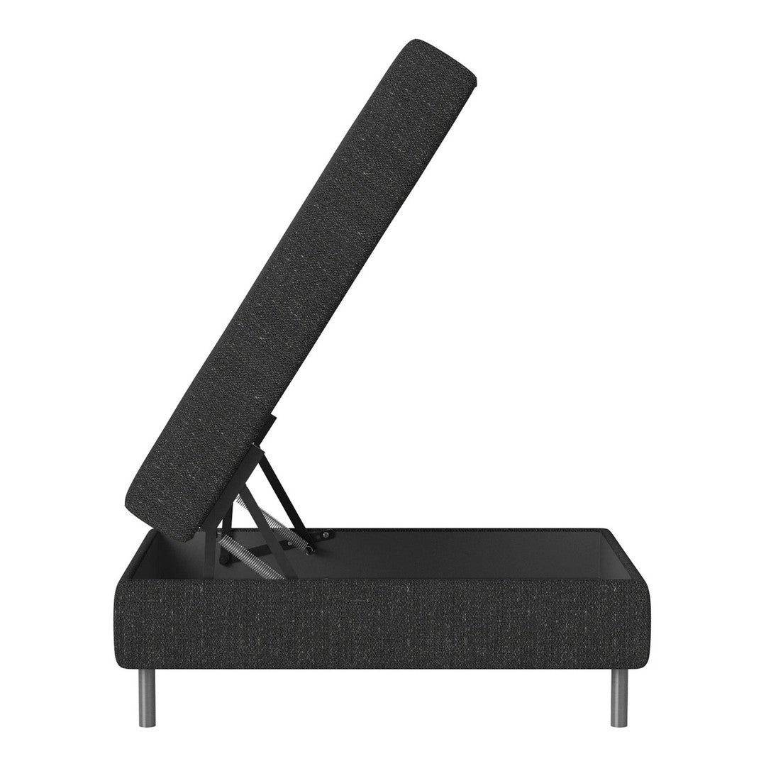 Black fabric ottoman with textured pattern, elevated to reveal storage space and minimalist silver legs.