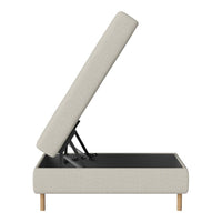 Light beige upholstered storage bed with a textured pattern and natural wood legs.