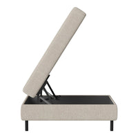 Light beige upholstered storage bed with a textured fabric and sleek black metal base. Modern, minimalist design.