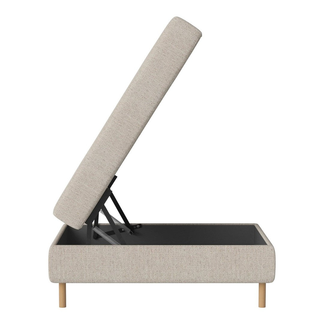 Beige upholstered storage ottoman with natural wood legs and a sleek, minimalist design. Modern and stylish.