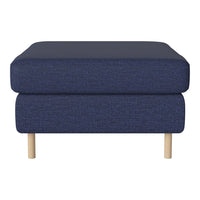 Navy blue upholstered ottoman with a textured pattern and light wood legs. Stylish and modern accessory for any space.