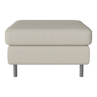 Light beige upholstered ottoman with a smooth, textured fabric and sleek metal legs. Ideal for modern interiors.