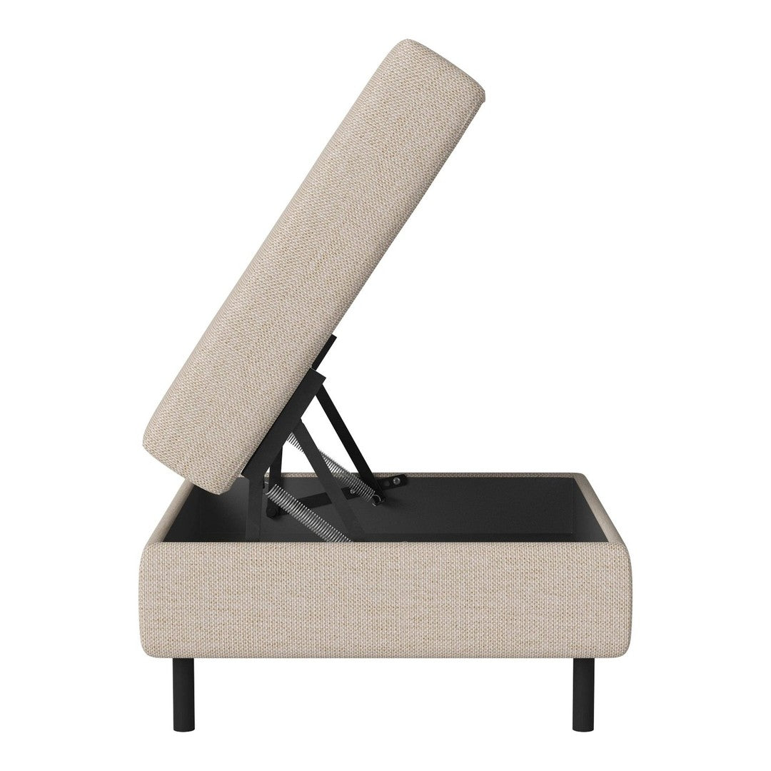 Beige upholstered ottoman with a modern minimalist style, featuring a smooth fabric and a sleek black base.