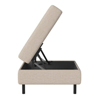 Beige upholstered lift-top storage ottoman with a sleek black base and minimalist design. Ideal for modern decor.