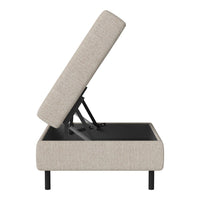 Light beige upholstered ottoman with a textured fabric pattern, featuring black metal legs and a lift-top design.