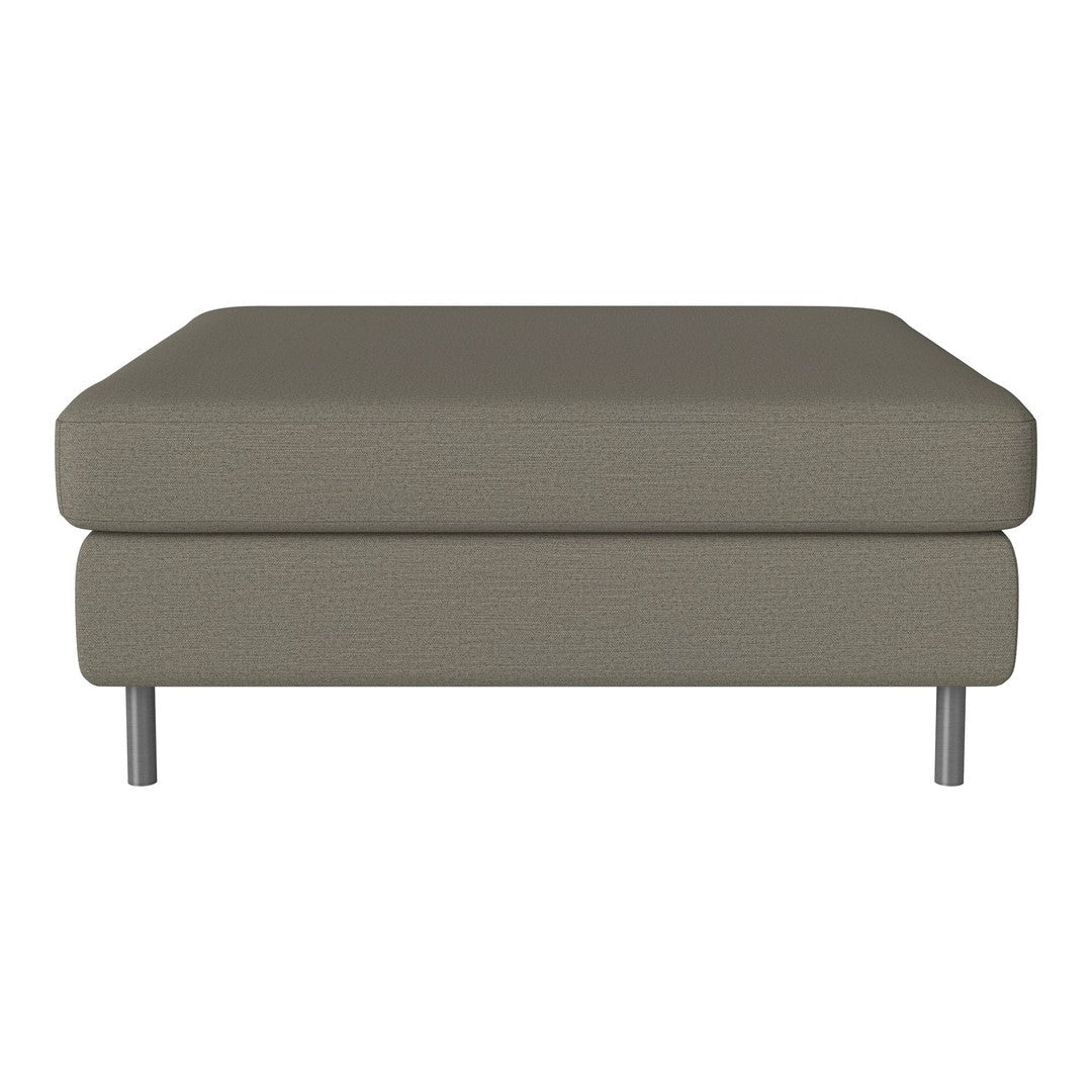 "Modern ottoman in soft gray fabric with subtle texture and sleek metal legs."