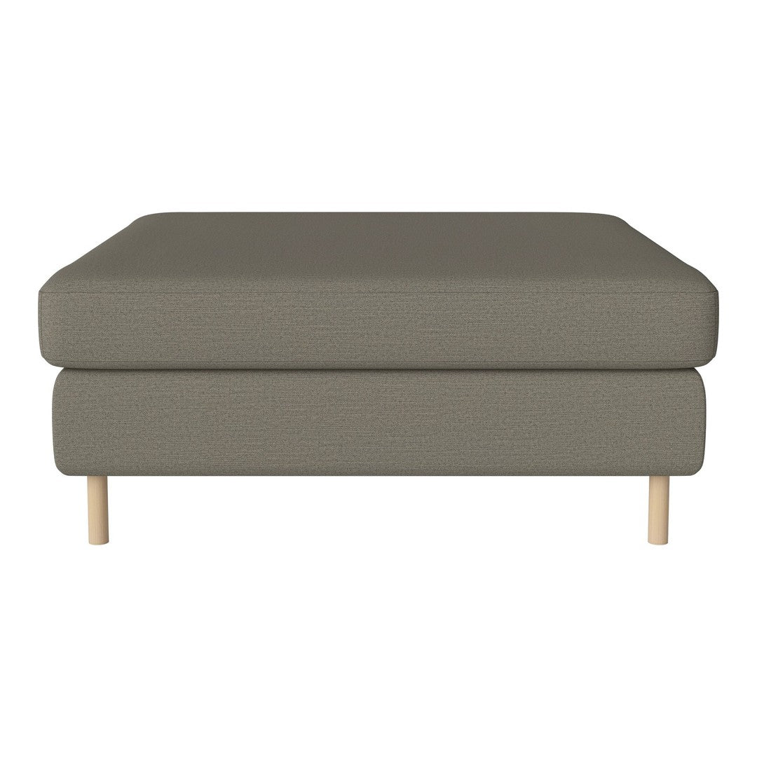 Olive green upholstered ottoman with a smooth texture and light wooden legs. Modern, minimalist design.