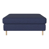 Navy blue upholstered ottoman with a textured fabric and natural wood legs, adding modern elegance to any decor.