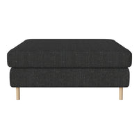 Modern black ottoman with textured fabric and natural wood legs. Stylish and versatile for any living space.