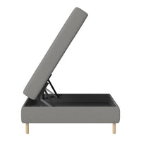 Gray upholstered ottoman with a clean, modern design and natural wood legs. Ideal for contemporary decor.