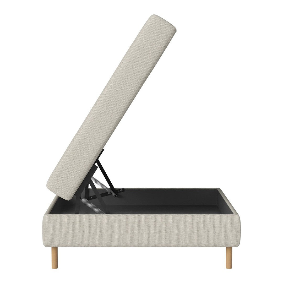 Light beige upholstered storage ottoman with a minimalist design and natural wood legs.