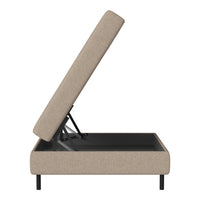 Beige upholstered storage bed with a simple design and black metal frame. Suitable for modern interiors.
