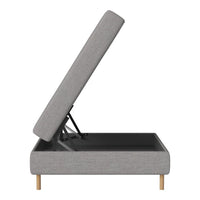 Light gray upholstered storage bed with natural wood legs, featuring a simple, modern design.