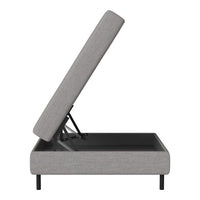 Grey upholstered storage bed with minimalistic design and sleek black base. Ideal for modern and stylish interiors.