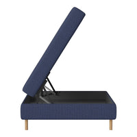 Blue upholstered storage bed with a textured pattern and natural wood legs, partially open to reveal interior space.