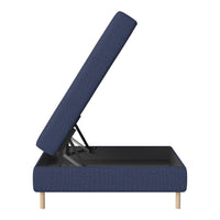 Navy blue upholstered storage bed with a textured pattern and light wooden legs, partially lifted to reveal storage space.