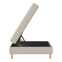 Light beige storage ottoman with a textured fabric and black interior, featuring wooden legs for a modern look.