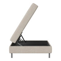 Beige upholstered storage bed with a lift-top design and sleek metal legs, featuring a minimalist and modern aesthetic.
