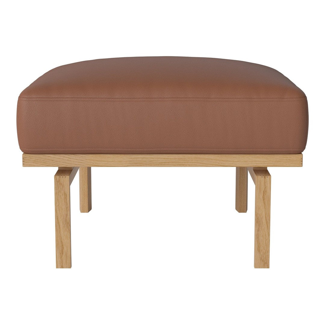 Brown leather ottoman with smooth textures and light wooden legs. Modern design perfect for any living space.