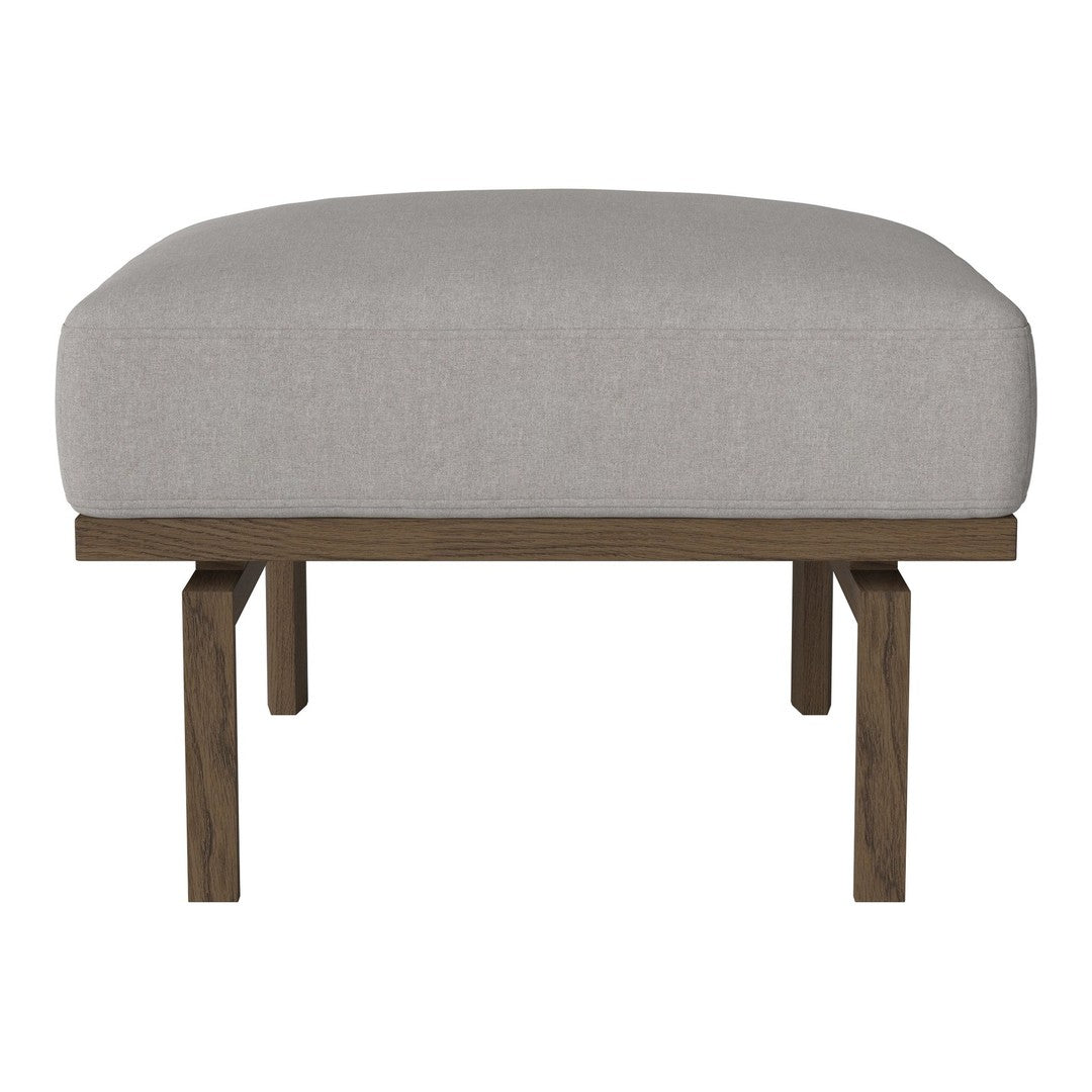 Gray upholstered ottoman with a minimalist design and dark wood legs. Simple and modern home decor accent.