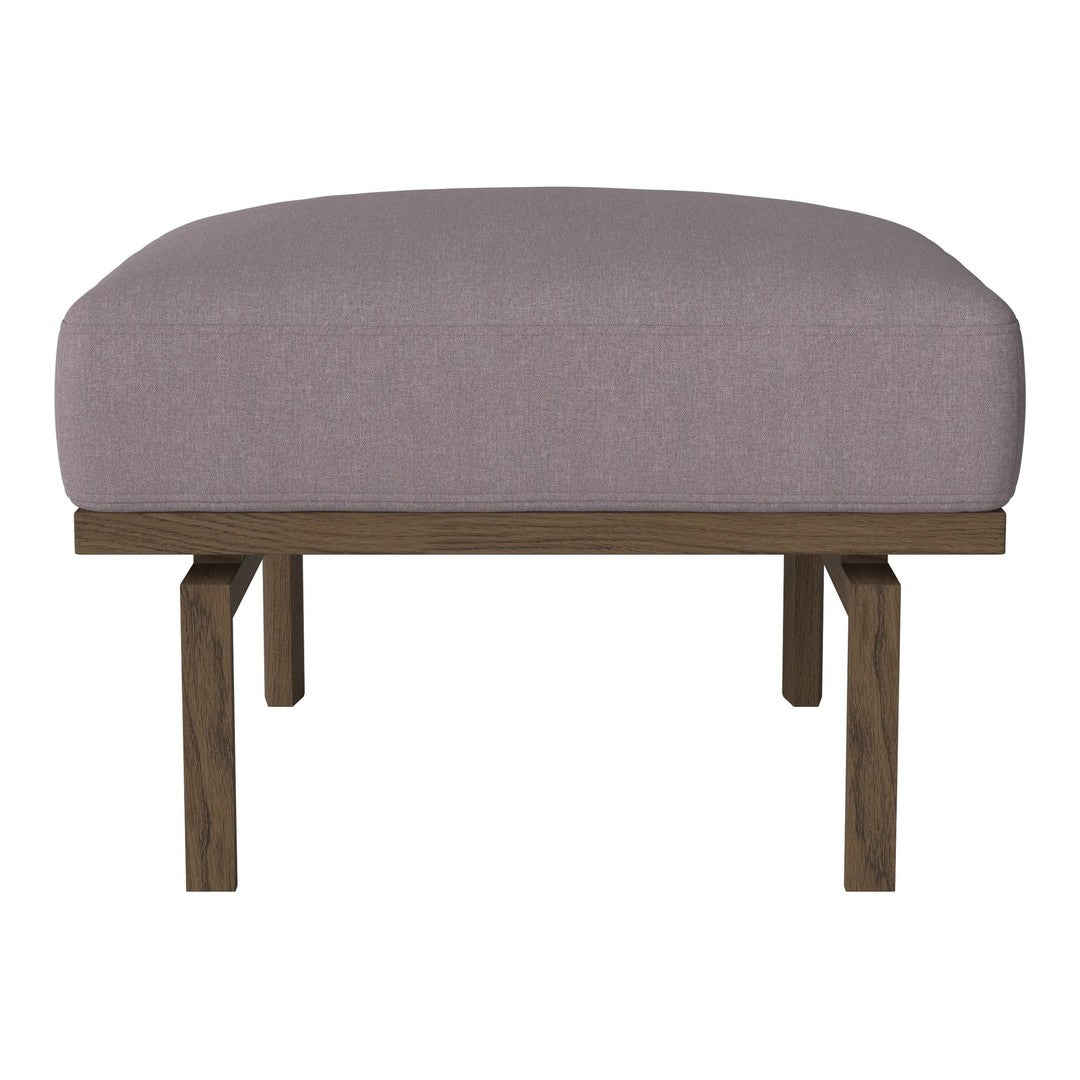 Pink upholstered ottoman on wooden legs, featuring a smooth, solid-patterned top and a minimalist design.