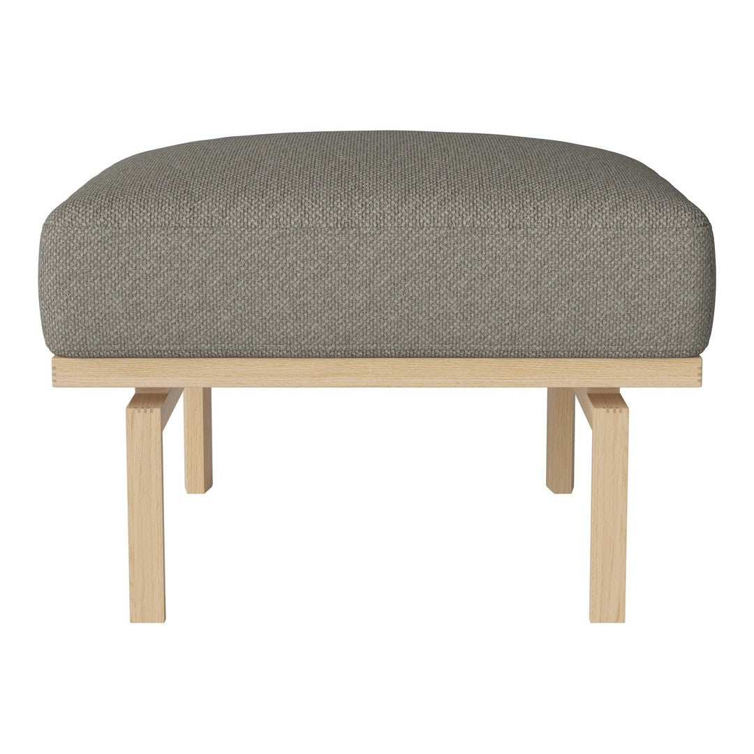 Gray upholstered ottoman with a smooth, rounded top and light wooden legs, perfect for adding a modern touch.