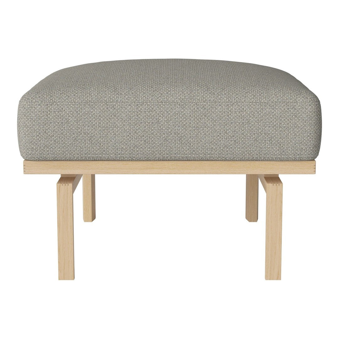 Light gray upholstered ottoman with subtle textured pattern and natural wood base.