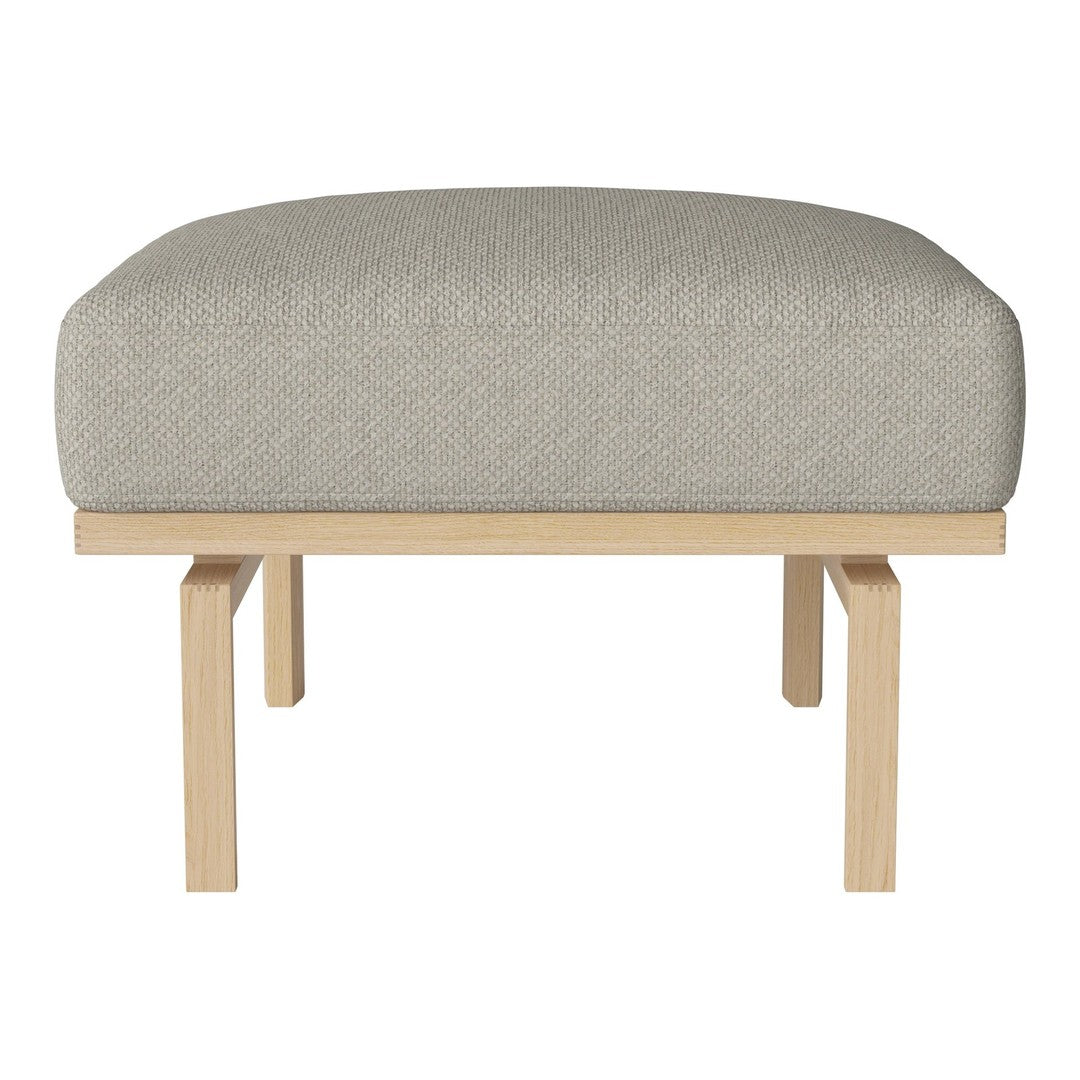 Cream upholstered ottoman with a textured finish, supported by a light wood frame. Modern and minimalist design.