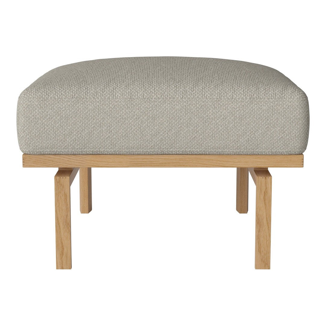 Light gray cushioned ottoman with a natural wood frame, featuring a simple, modern design perfect for any decor.