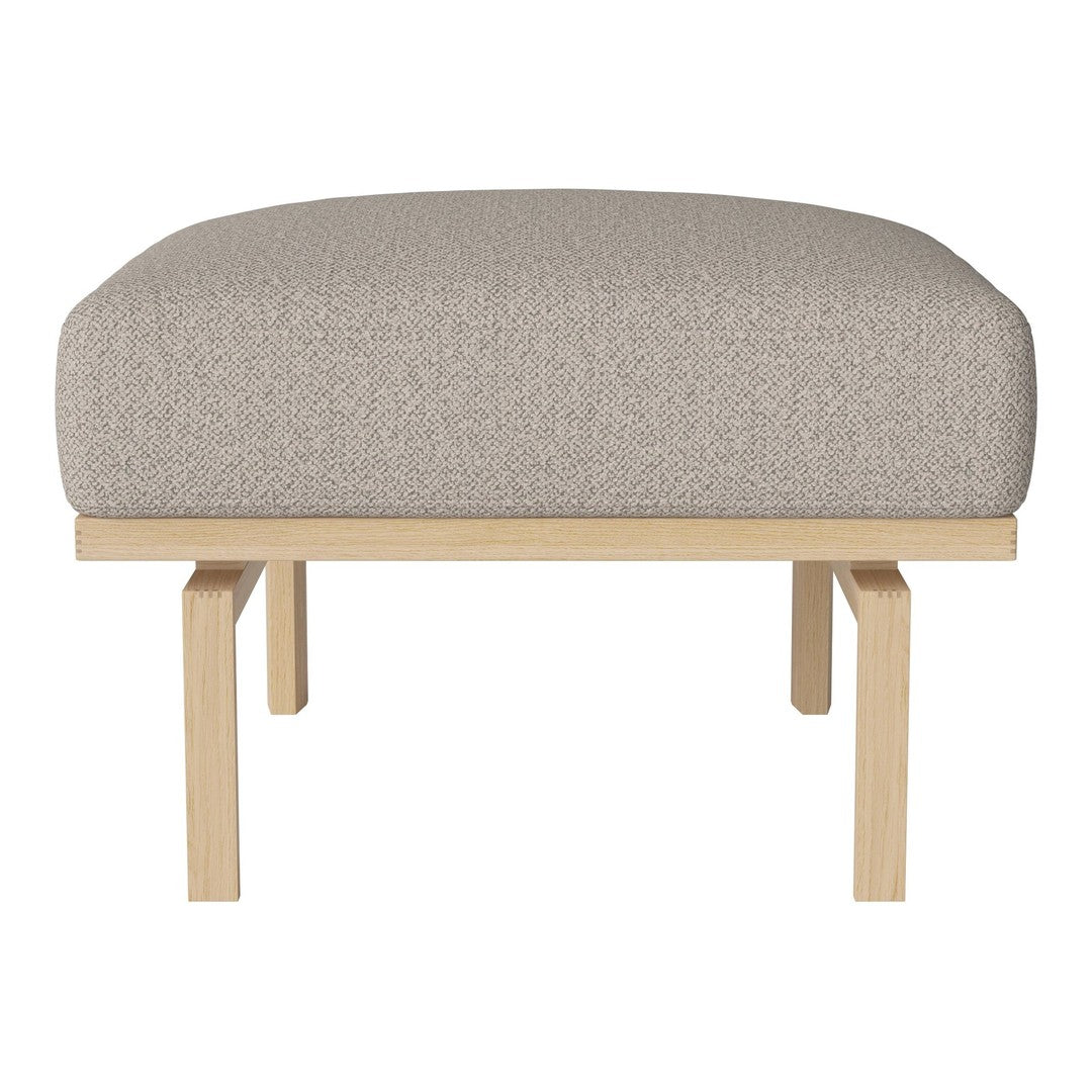 Light beige upholstered ottoman with a textured pattern and natural wood legs. Ideal for modern decor.
