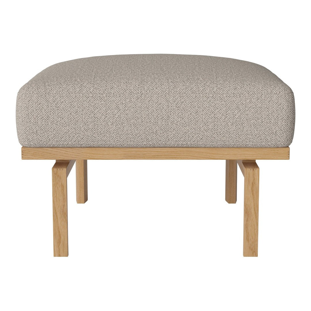 Beige upholstered ottoman with a textured fabric top and natural wood legs, perfect for modern decor.