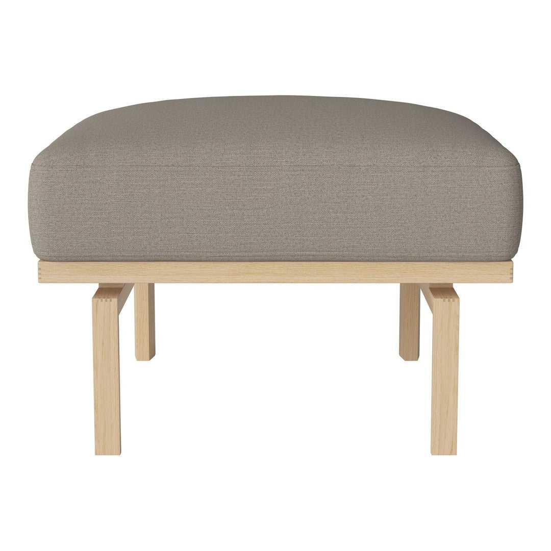 Gray upholstered ottoman with a smooth texture and natural wood legs. Ideal for modern interior decor.