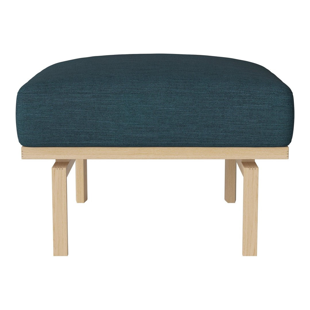 Teal upholstered ottoman with a minimalist wooden frame, featuring a smooth, modern design and subtle texture.